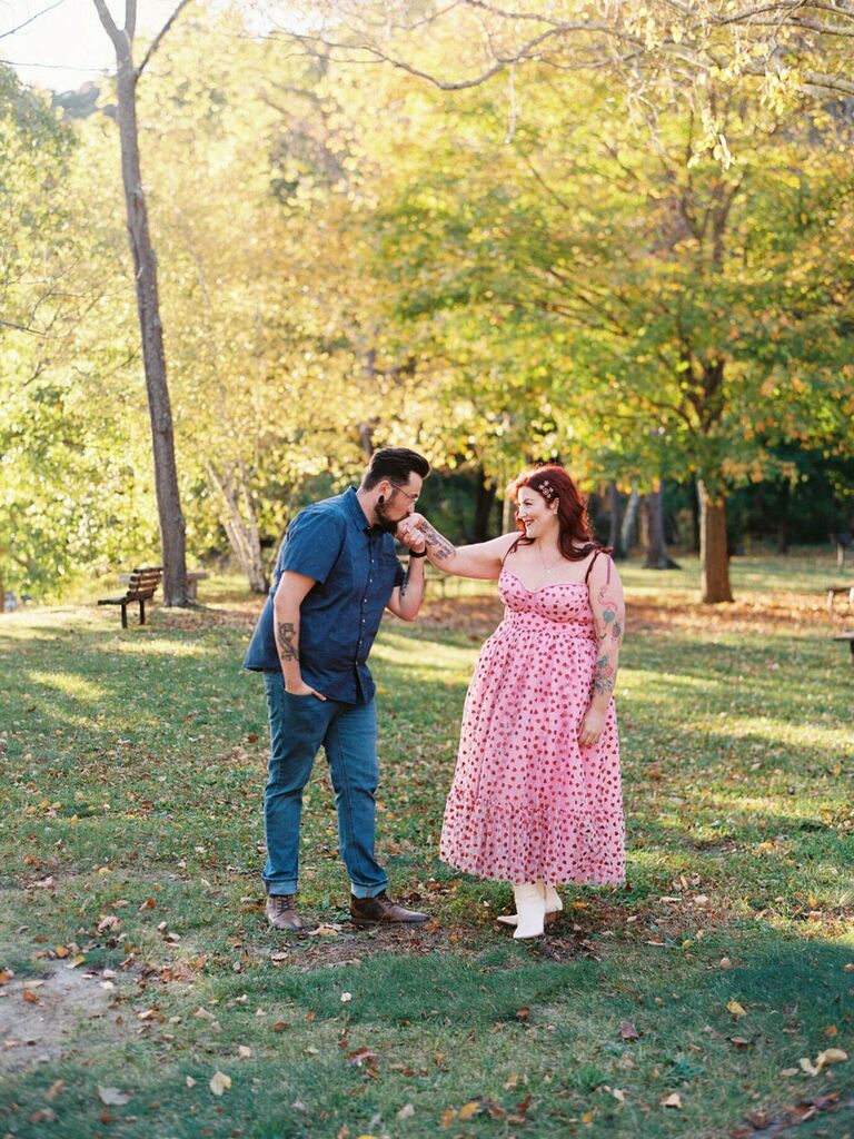 Cute Couple Poses: Man kisses his wife's hand while looking into her eyes. 