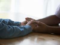 Couple holding hands on a table