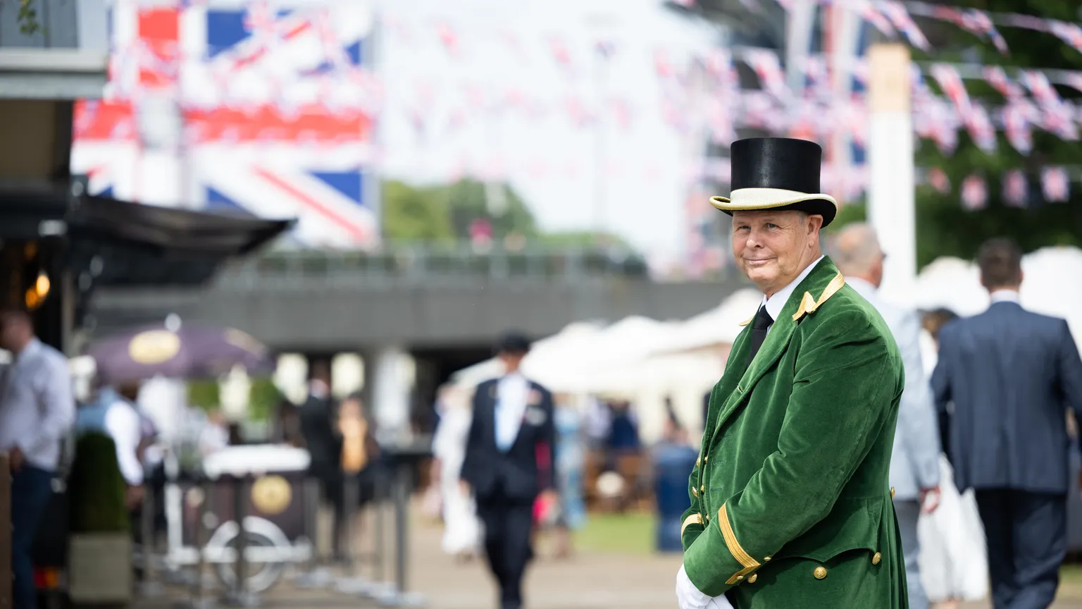 A Greencoat wearing the official livery stands on the Bandstand walkway at Royal Ascot