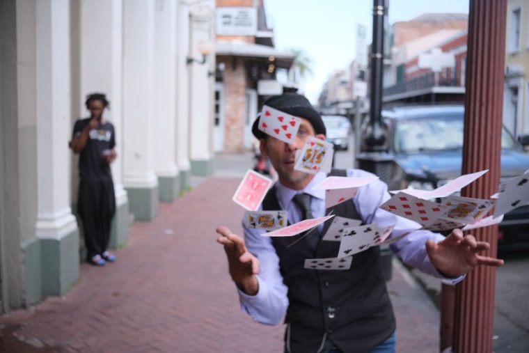 Man throwing playing cards in the air