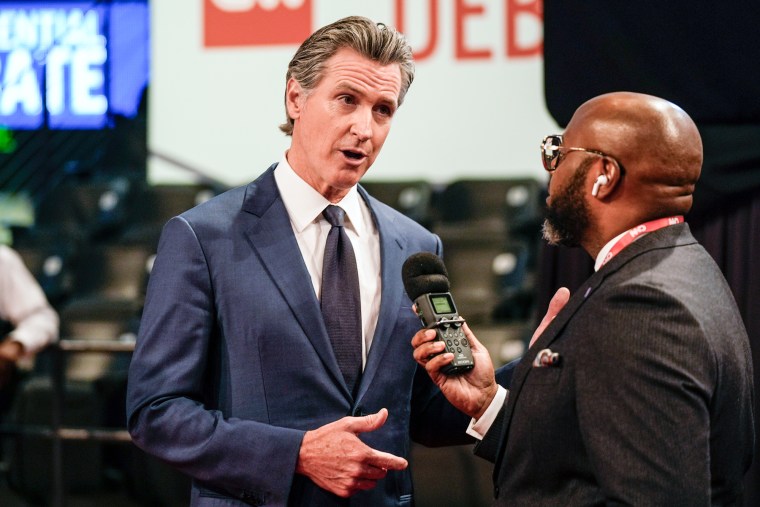 Gavin Newsom speaks to a reporter