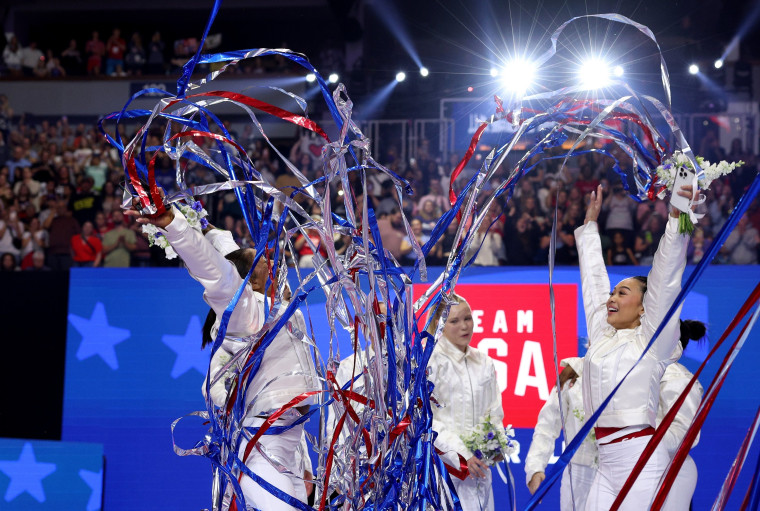 Jordan Chiles, Jade Carey and Suni Lee celebrate after being selected for the 2024 U.S. Olympic Women's Gymnastics Team.