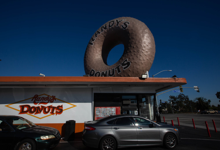 People enjoy wait in line for the iconic Randys Donuts in South LA