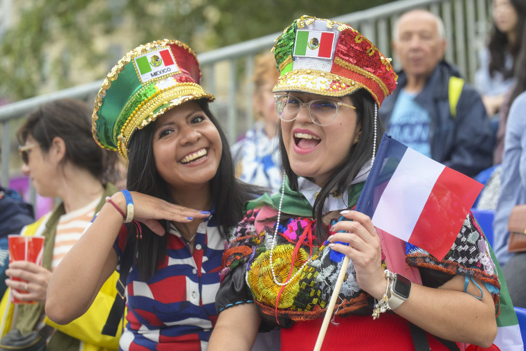 Sports enthusiasts arrive ahead of the Paris 2024 Olympic Games opening ceremony.