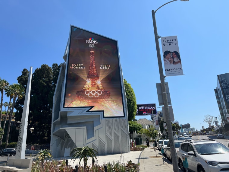 A Paris Olympics billboard at a Tesla charging station in West Hollywood.