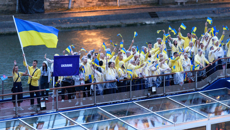 Ukraine and flagbearer Mychajlo Romantschuk during the athletes’ parade on the River Seine during the Opening Ceremony of the Olympic Games.