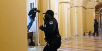 A Capitol police officer shoots pepper spray at Michael Sparks as he enters the Capitol