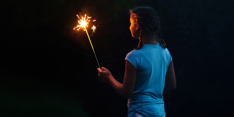 kid holding sparkler