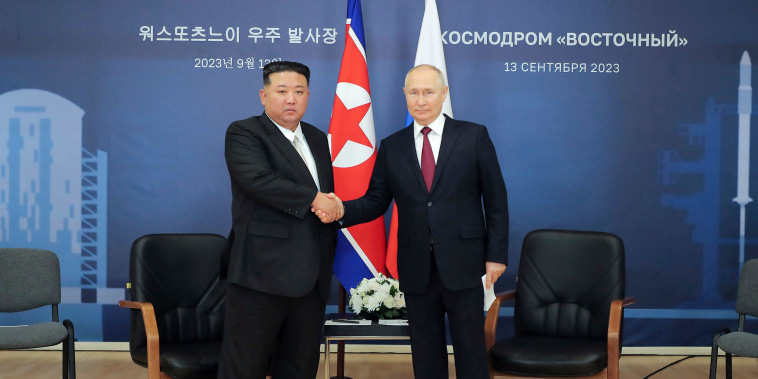 Kim Jong Un, left, and Vladimir Putin shake hands before their talk at the Vostochny cosmodrome outside the city of Tsiolkovsky, Russia