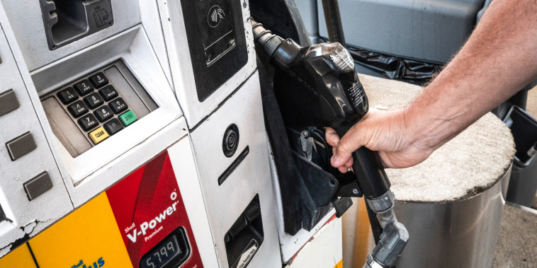 A hand on a gas pump