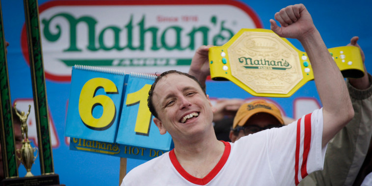 Joey Chestnut celebrates after winning the 98th annual Nathan's Famous Hot Dog Eating Contest at Coney Island on July 4, 2014 in the Brooklyn borough of New York City.  Chesnut won his eighth straight Nathan's Hot Dog Eating Contest with 61 hot dogs. 