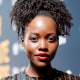 Lupita Nyong'o stands for a portrait on the red carpet