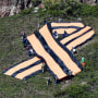 People hold a big ribbon of Saint George on a mountain slope in Divnogorsk, Russia.