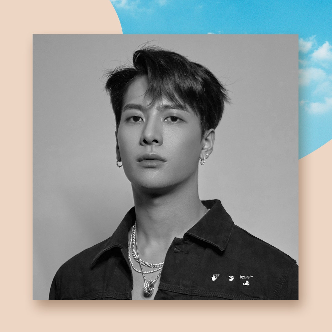 Jackson Wang wearing black denim jacket in press photo.