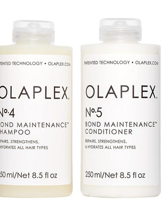 Two white bottles of the Olaplex No. 4 Bond Maintenance Shampoo  No. 5 Bond Maintenance Conditioner on a white background