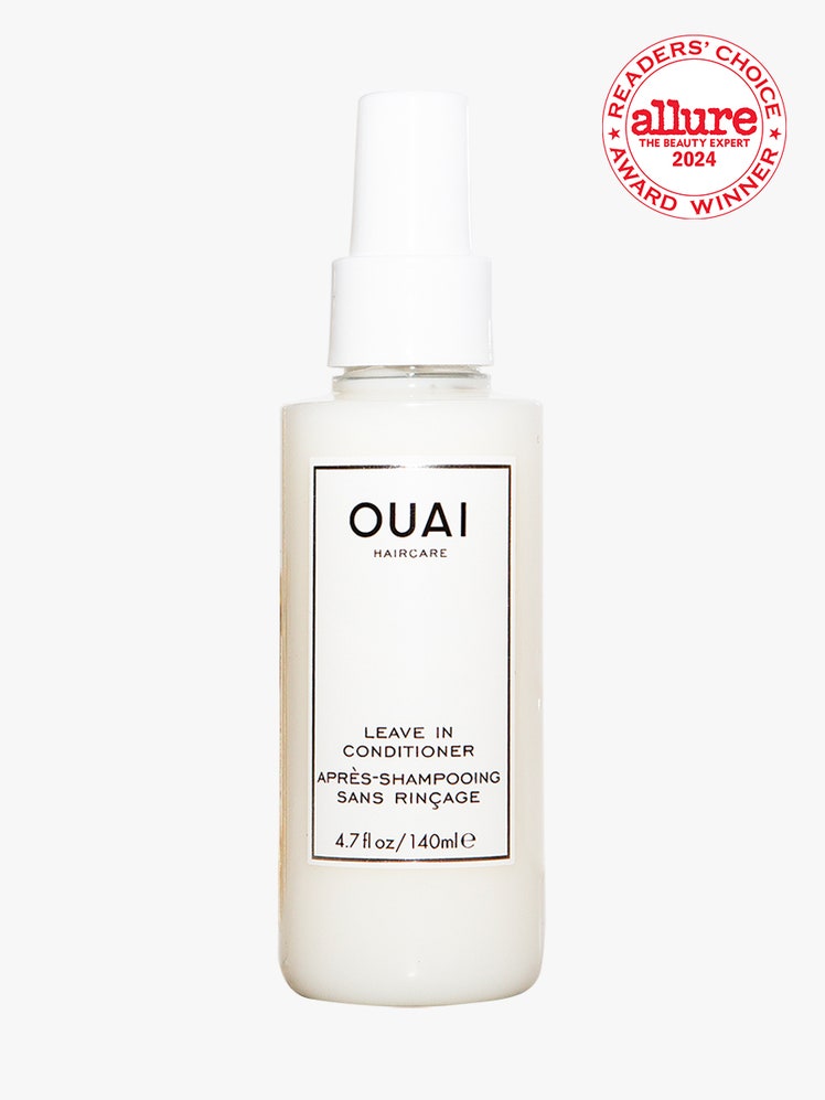 Ouai LeaveIn Conditioner white spray bottle on light gray background with white and red Allure Readers' Choice Award...