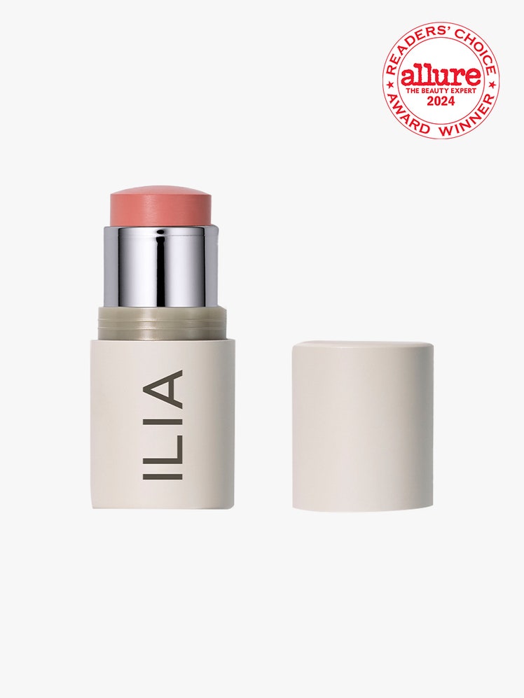 Ilia MultiStick Cream Blush  Highlighter  Lip Tint beige twist up stick of pink cream blush with cap to the side on...