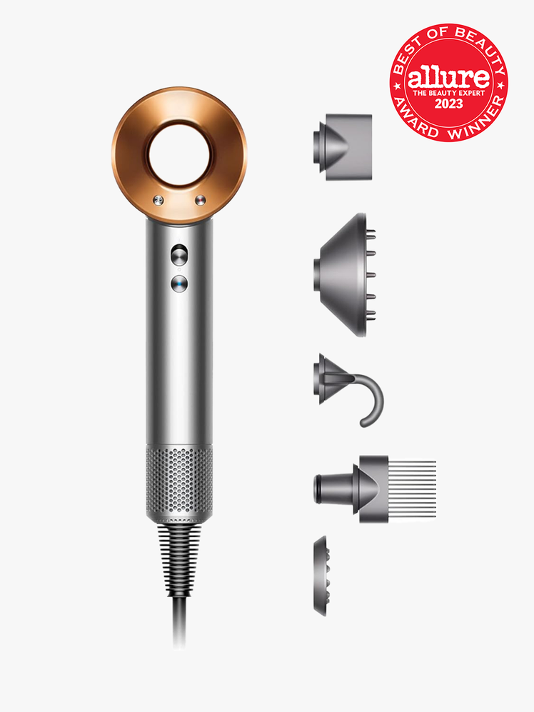 Dyson Supersonic silver blow-dryer on light gray background with red Allure BoB seal in the top right corner