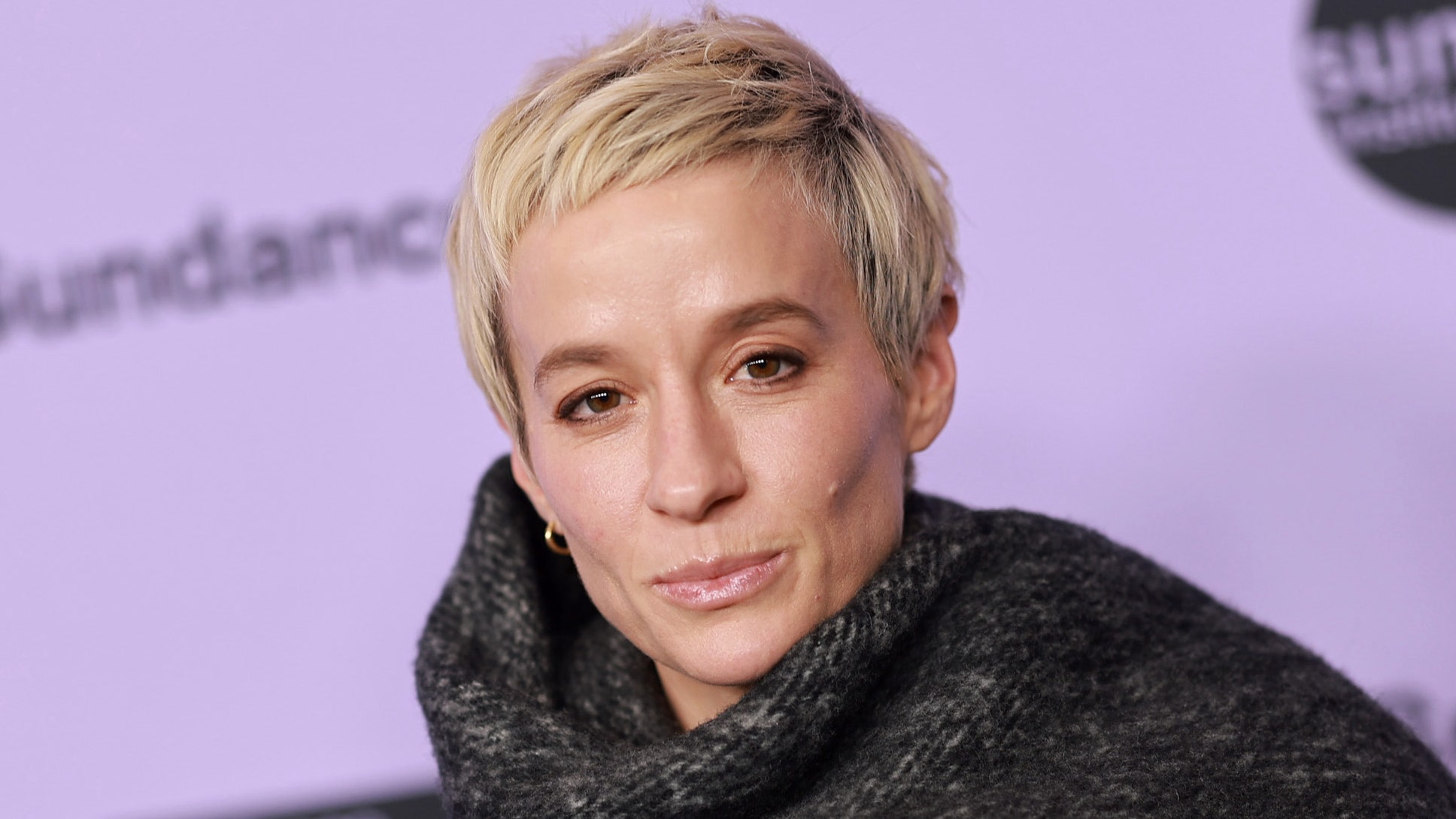 Megan Rapinoe against a lavender background