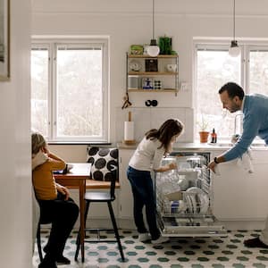 Daughter helping dad unload the dishwasher