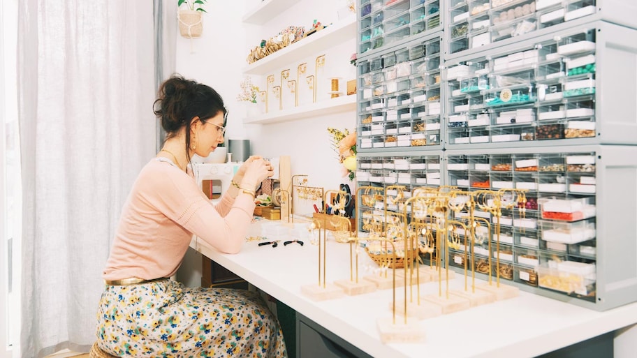 Designer working in studio creating handmade earrings