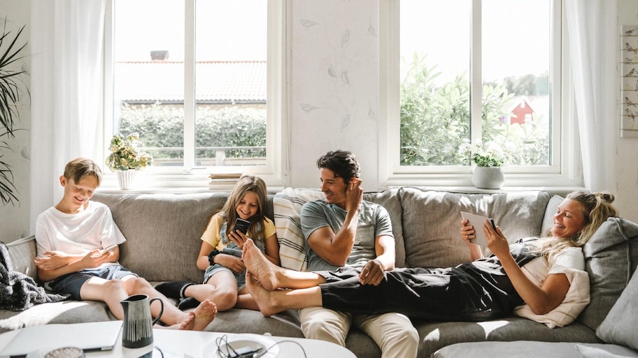 Happy family sitting on sofa in the living room