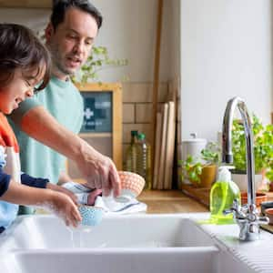 Father and son cleaning dishes