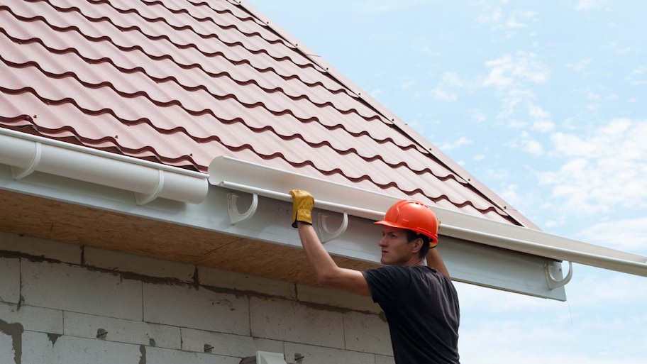 Worker installing the gutter system