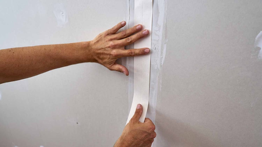 Man adding laminated plasterboard 