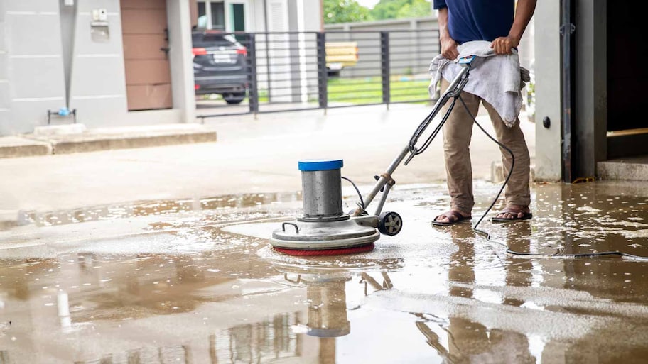 Man cleaning the floor with scrubber machine