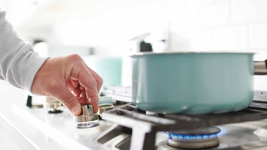 Man cooking on a gas stove