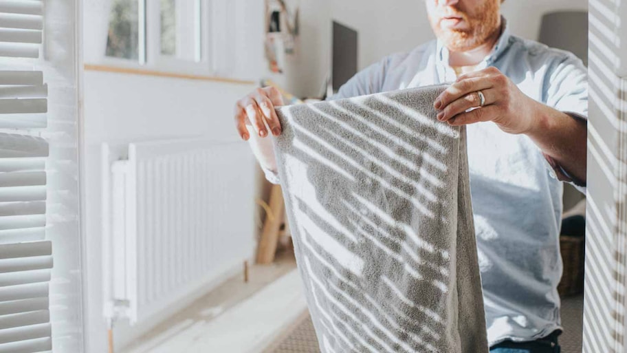 Man folding towel