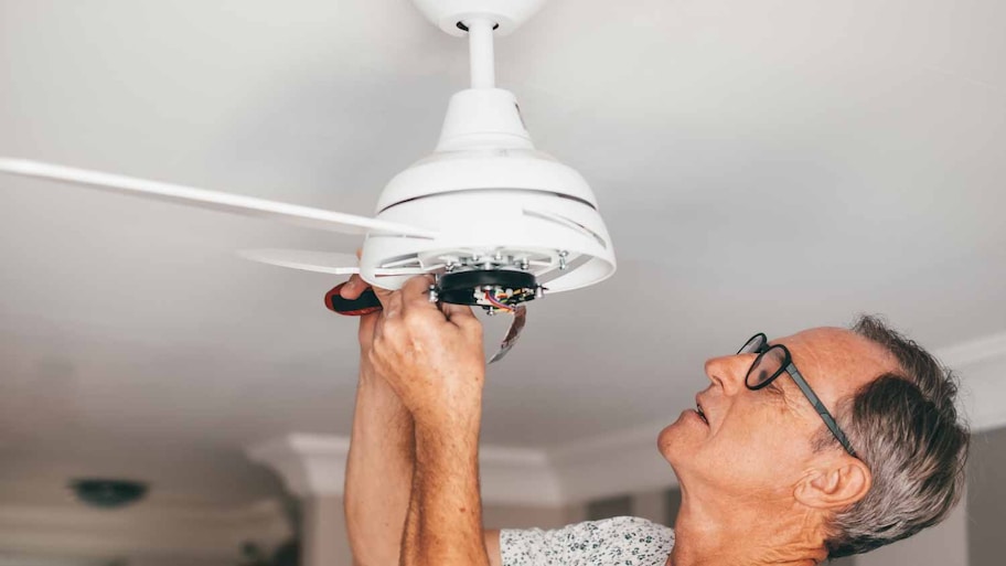 Man installing a paddle fan