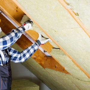 Man installing thermal roof insulation layer