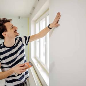 Man preparing the wall for the painting