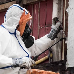 Man removing asbestos on a construction site