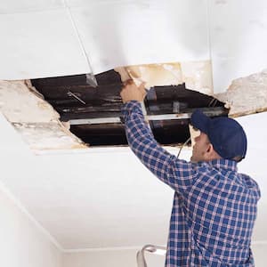 Man repairing collapsed ceiling