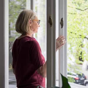 Mature woman opening the window