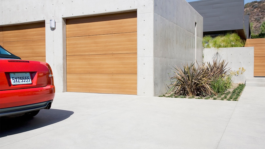 Modern garage with car on a concrete driveway