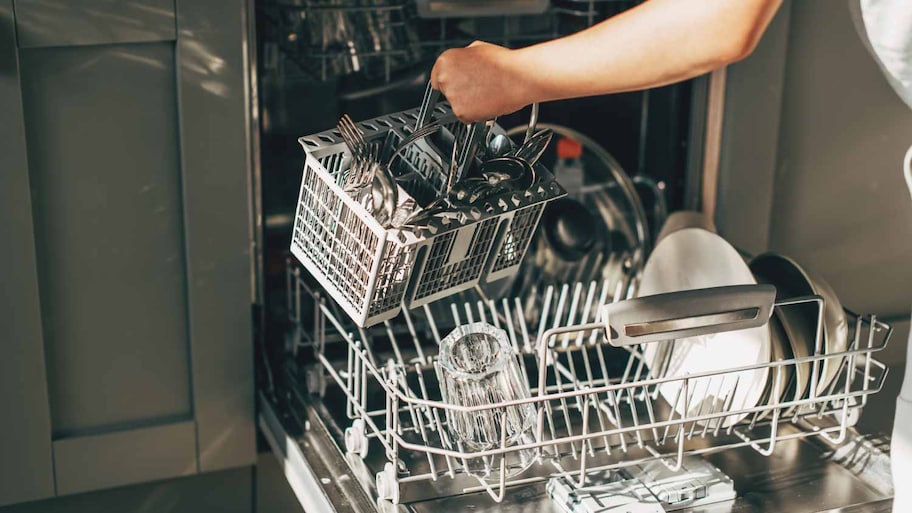 Open dishwasher with clean utensils 