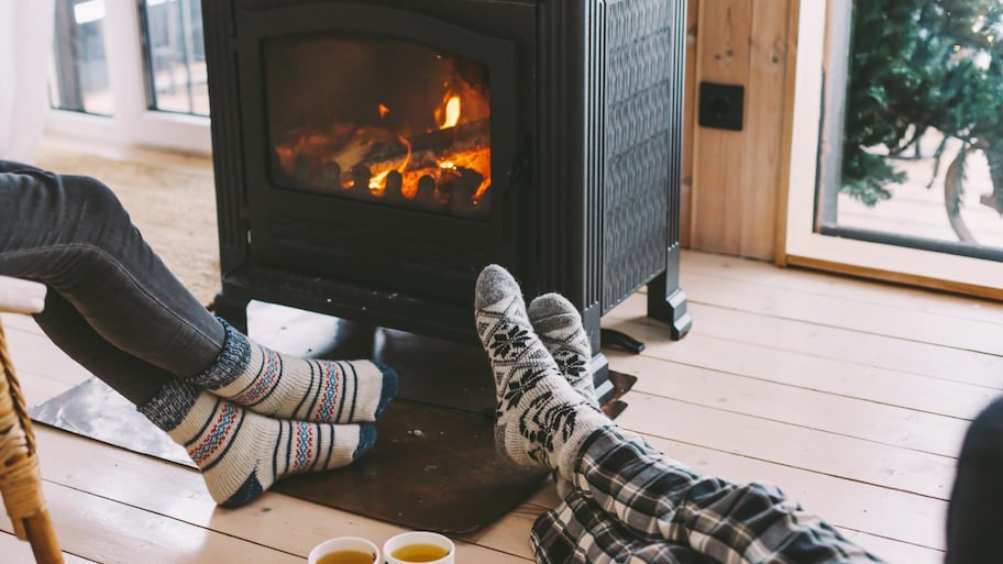 People drinking tea and resting by the stove