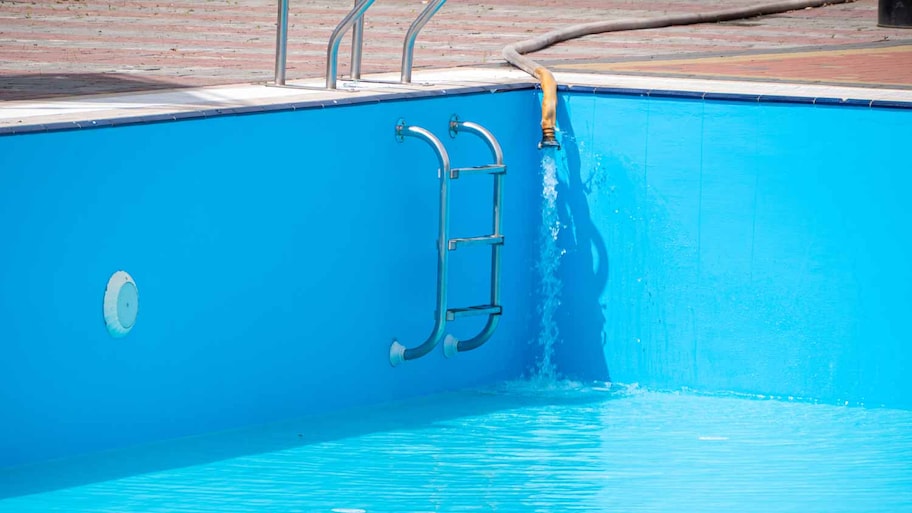 Pouring fresh water into swimming pool