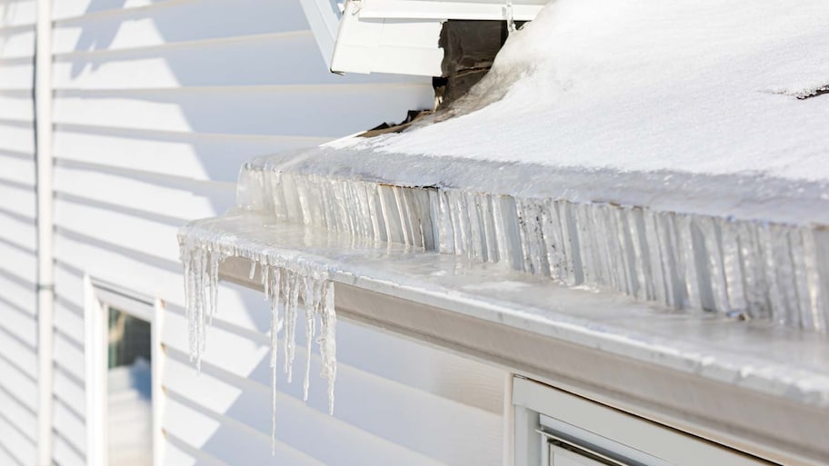 Roof gutters full of ice after a winter storm