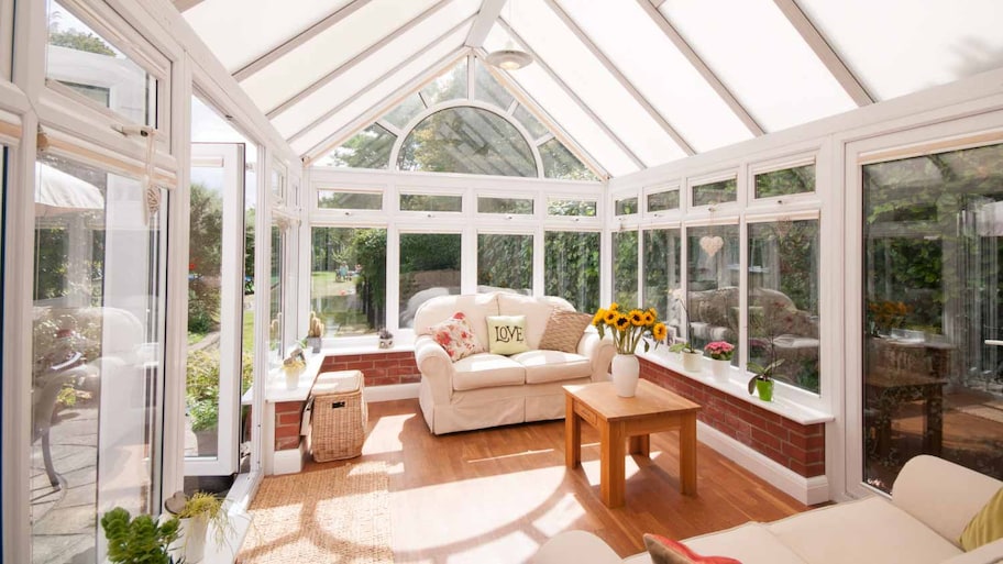 White conservatory with beige sofa