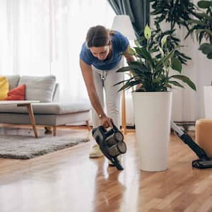 Woman cleaning wooden floor