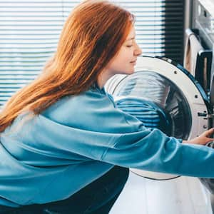 Woman doing laundry at home