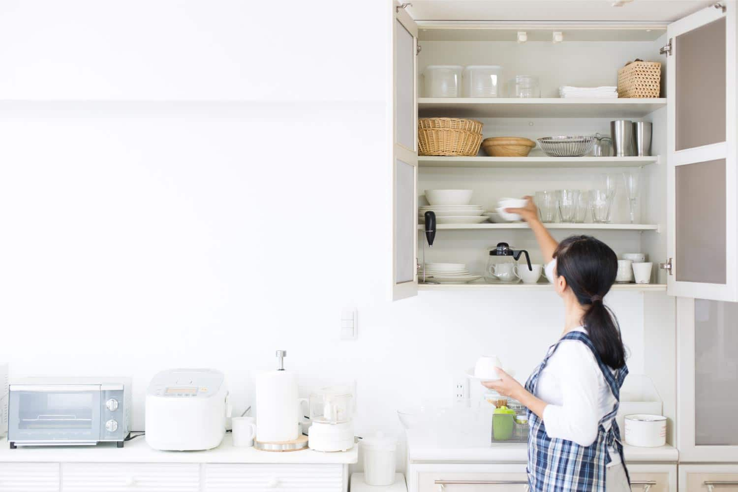 Woman organizing kitchen