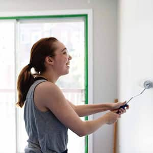 Woman painting living room