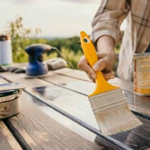 Woman painting old table