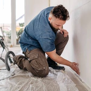 Worker installing drywall 